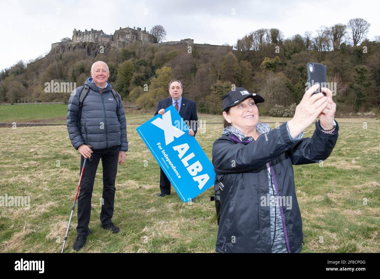 Stirling, Scotland, UK. 13th Apr, 2021. PICTURED: (Middle) Rt Hon Alex Salmond - Alba Part Leader seen posing for a photo with some walkers who were passing by the Castle grounds. Alba Party Leader, Rt Hon Alex Salmond unveils his candidates for Mid Scotland and Fife region. Pic Credit: Colin Fisher/Alamy Live News Stock Photo