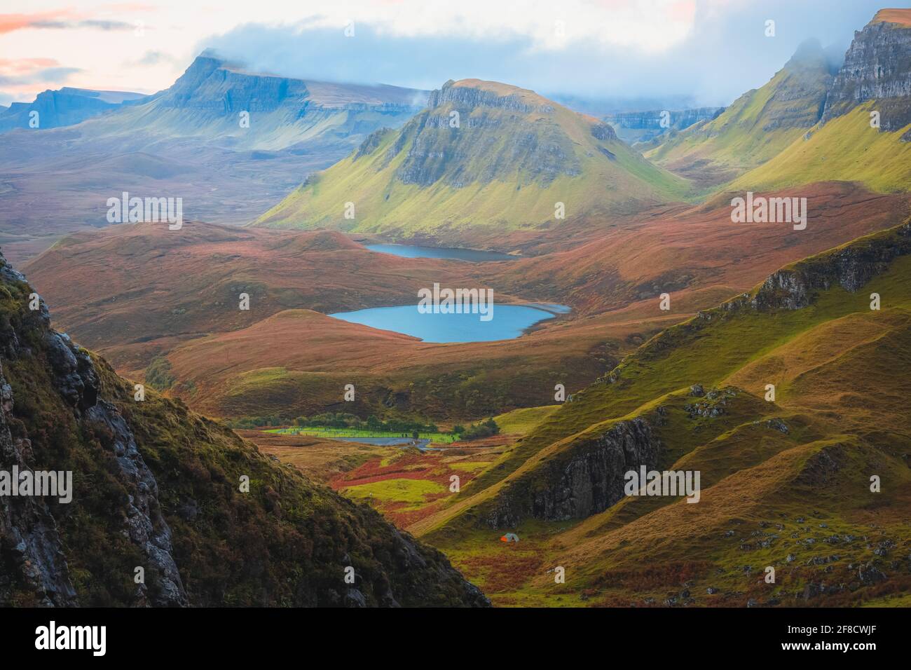 Epic mountain landscape view of the rugged, contoured terrain of the otherworldly Cleat at the Quiraing on the Isle of Skye, Scotland. Stock Photo
