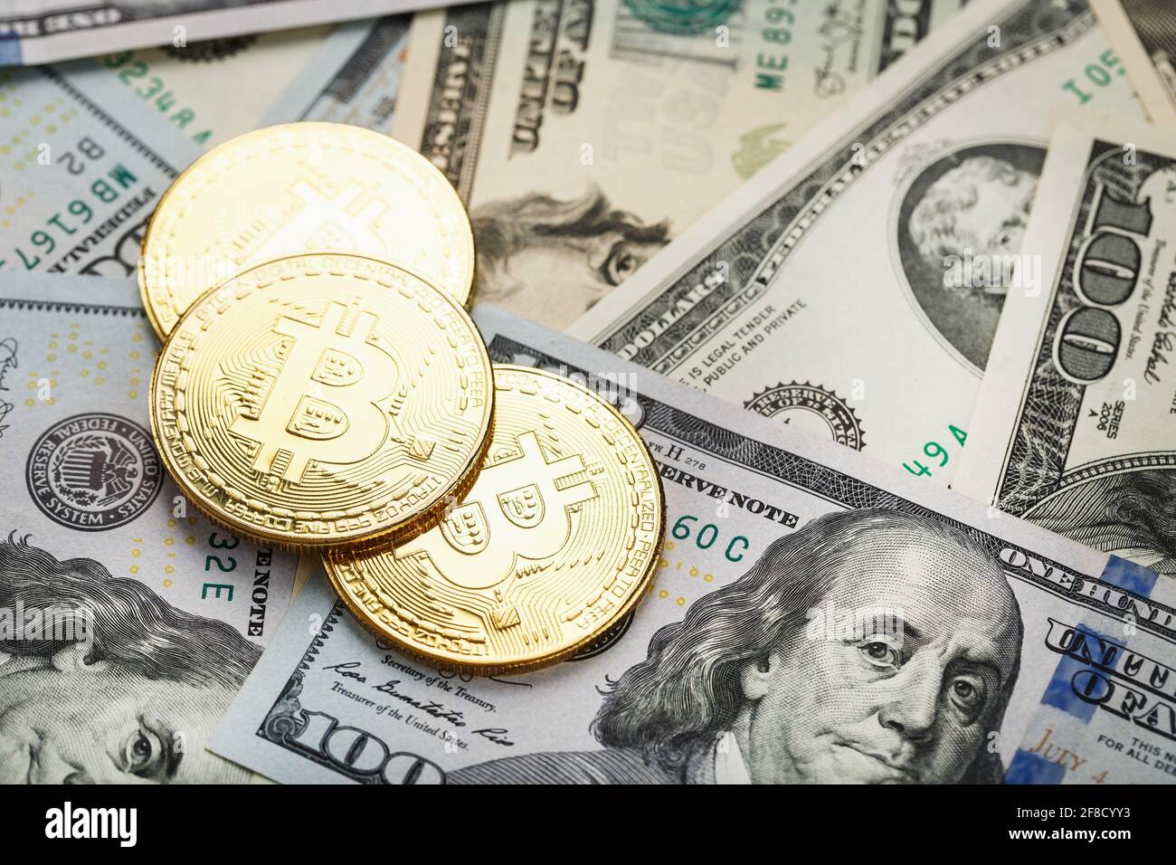 over dollar banknotes. CrypGold bitcoin coins on the background of dollar  bills with the concept of the exchange rate of the financial markets.  Bitcoi Stock Photo - Alamy