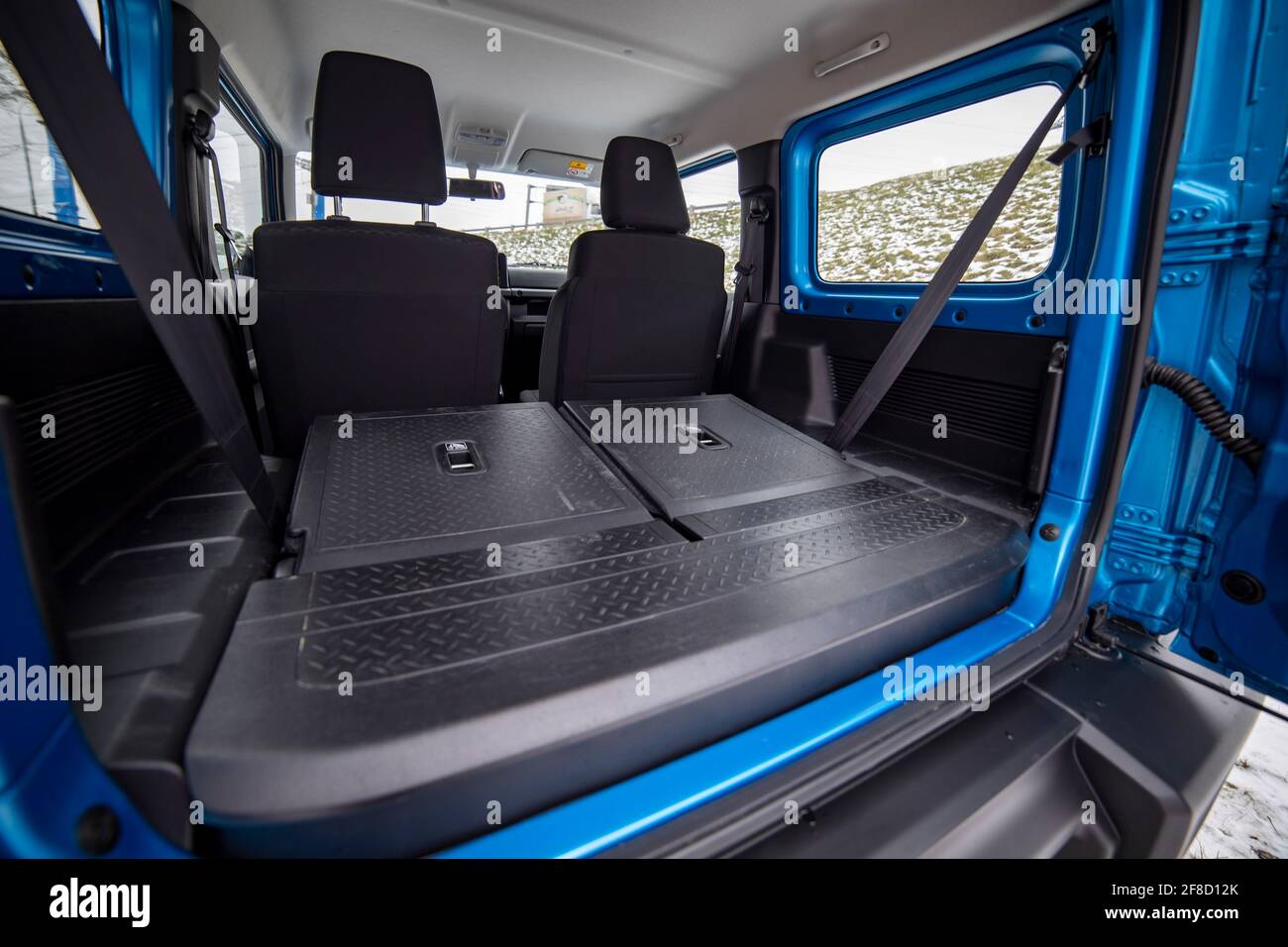 side view of empty open car trunk with seats folded into flat flor of suv crossover. open trunk door Stock Photo
