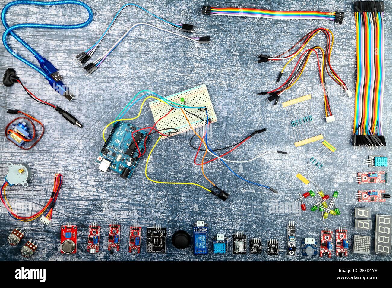 Arduino uno and electronic components flatlay on a blue rustic background Stock Photo