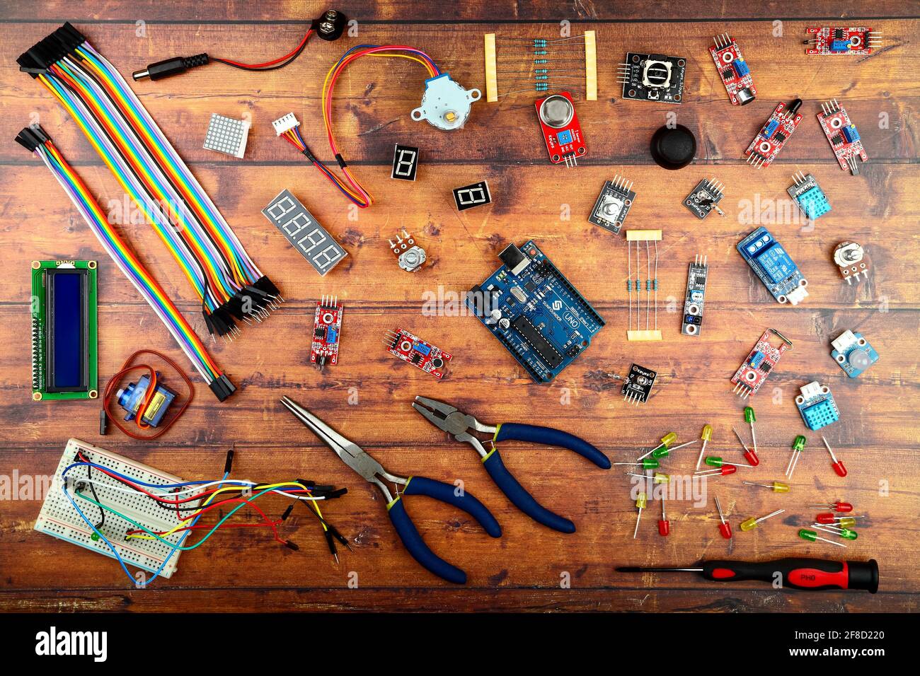 Arduino uno and electronic components flatlay on a wooden rustic background Stock Photo