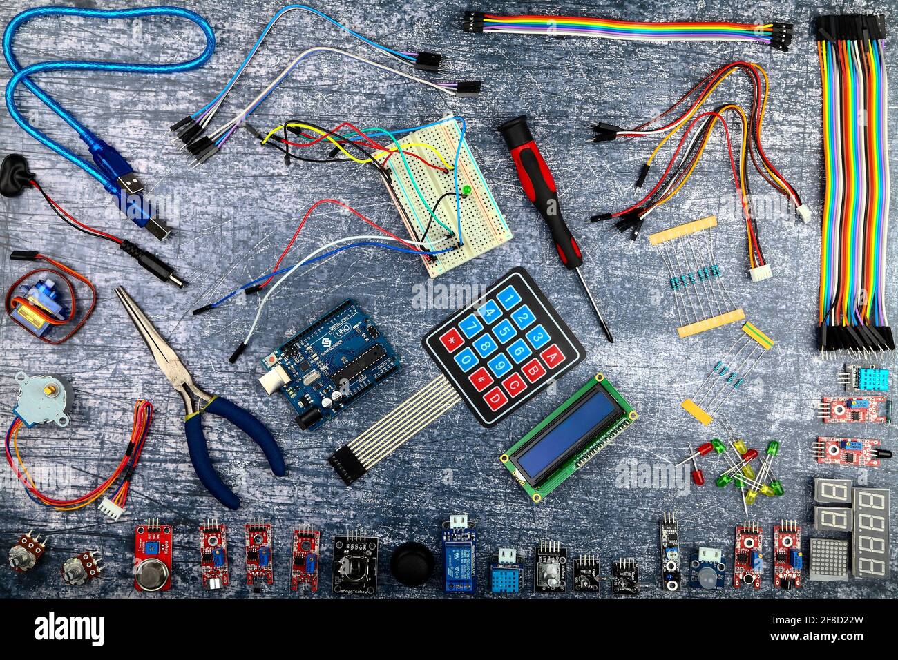 Arduino uno and electronic components flatlay on a blue rustic background Stock Photo