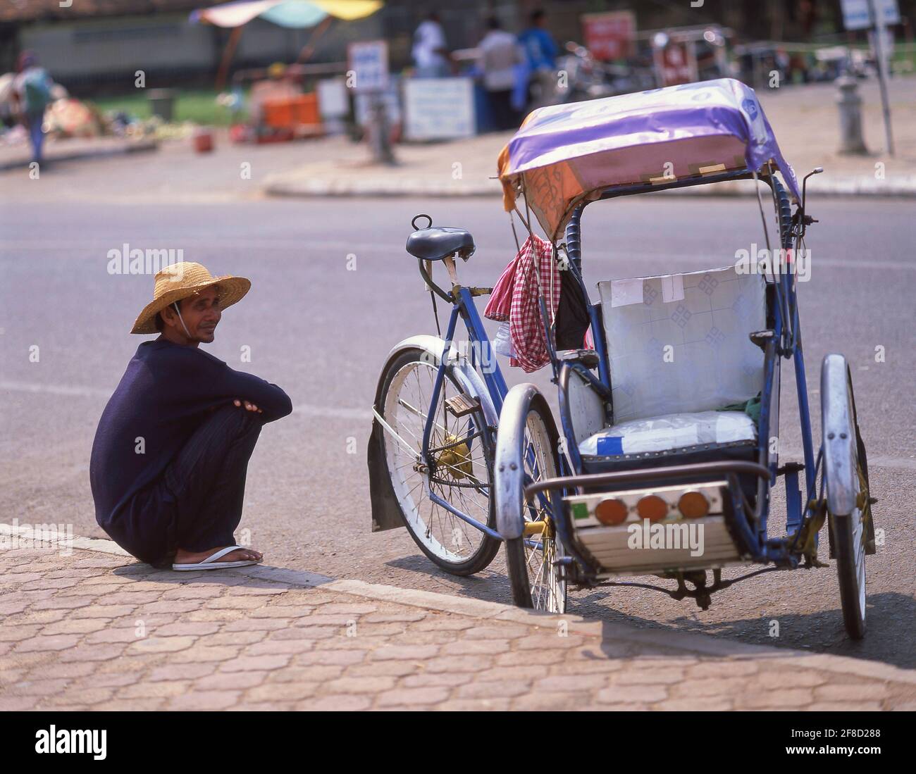 Male driver with pedicab, Phnom Penh, Kingdom of Cambodia Stock Photo