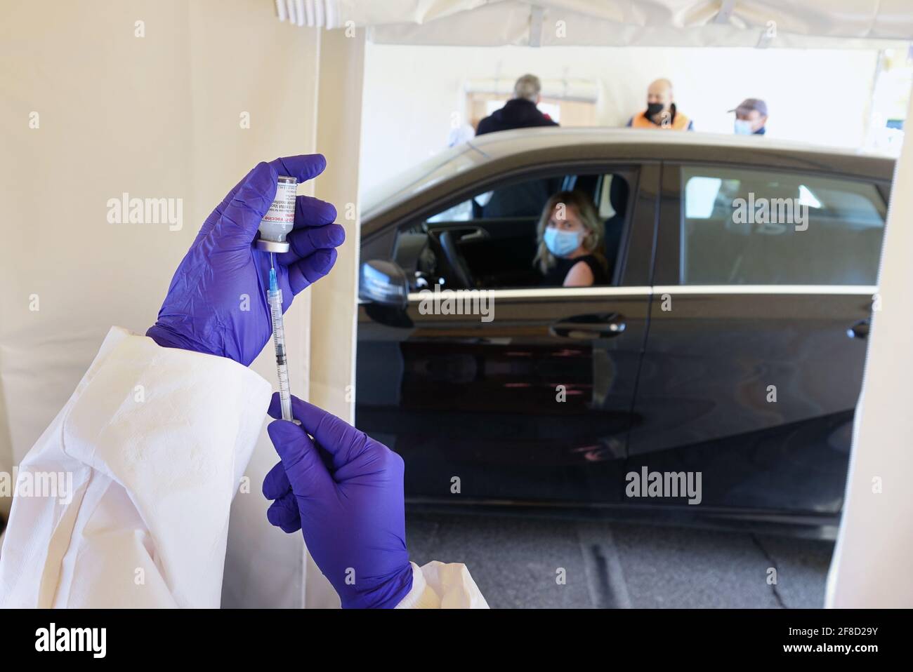 Mass vaccination campaign, inoculation of vaccine in the car at a drive-through vaccine site. Turin, Italy - April 2021 Stock Photo