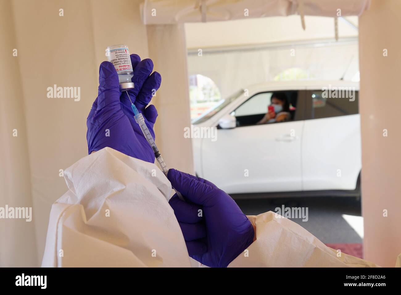 Mass vaccination campaign, inoculation of vaccine in the car at a drive-through vaccine site. Turin, Italy - April 2021 Stock Photo
