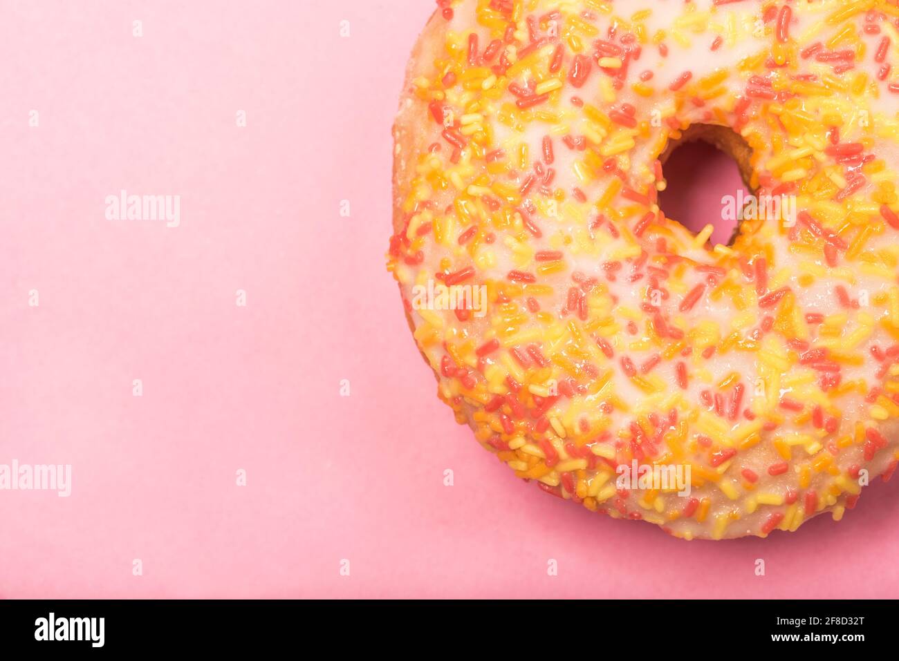 Close up of a colourful iced ring doughnut with sprinkles Stock Photo