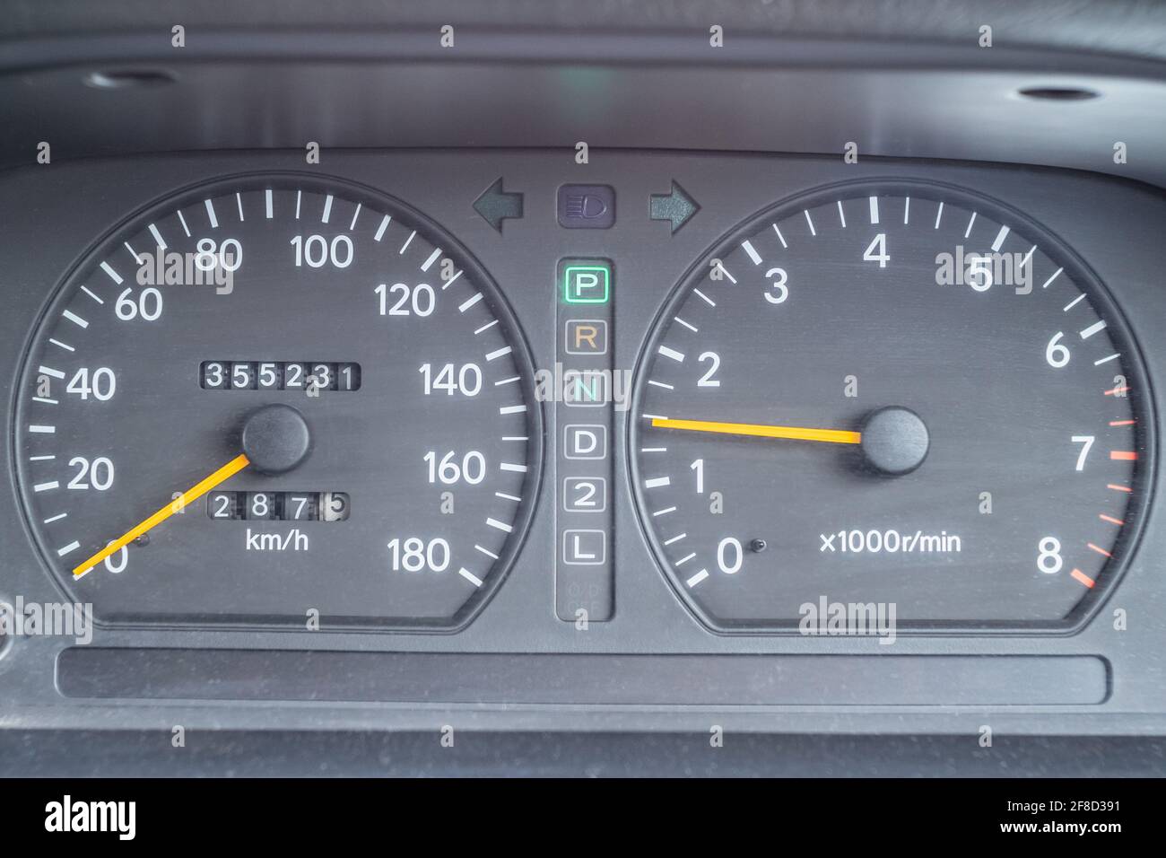 An old analog dashboard of a Japanese car. Closeup speedometer up to