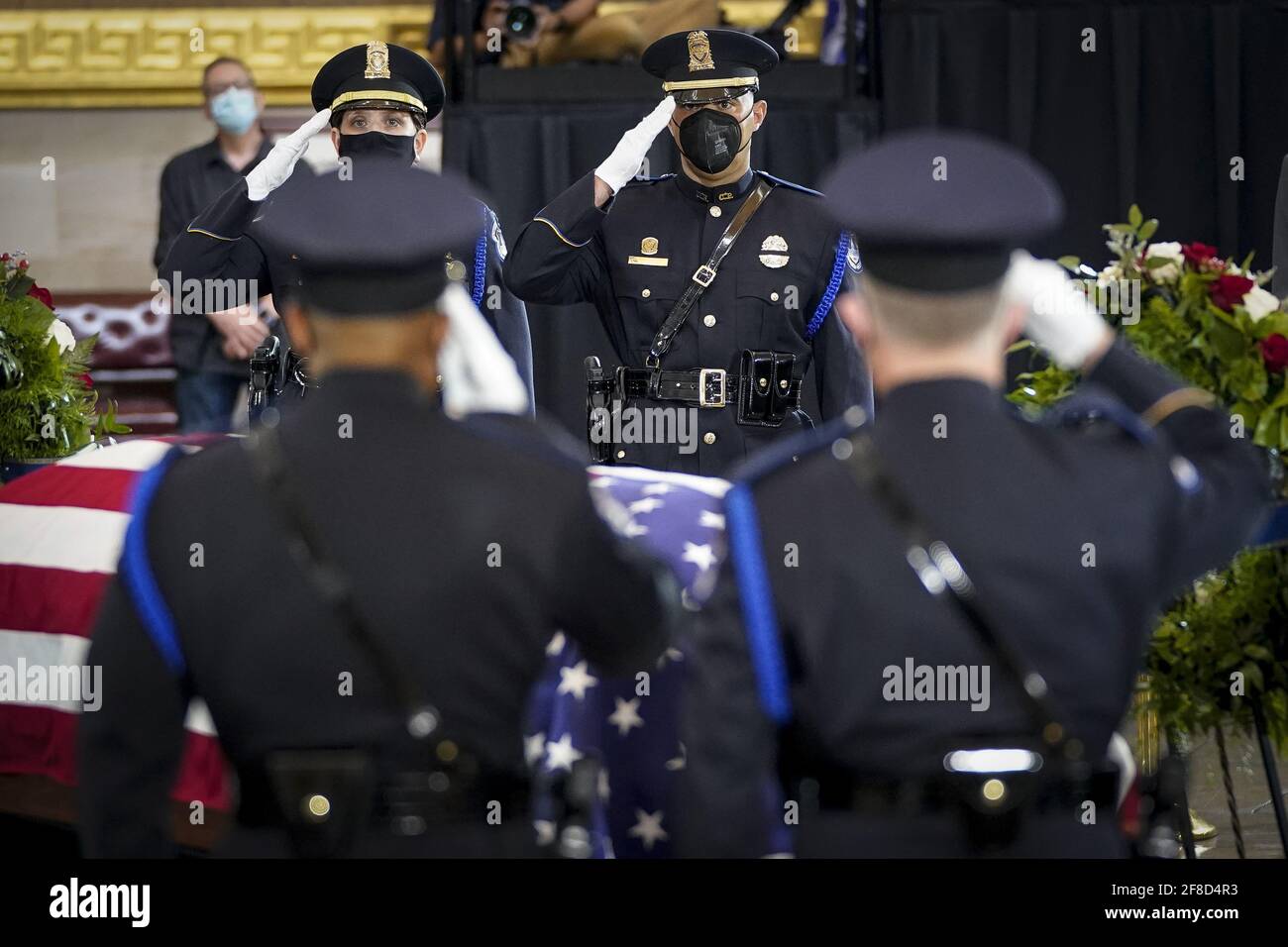 Members of a Capitol Police honor guard salute at the casket of the late U.S. Capitol Police officer William 'Billy' Evans during a memorial service as Evans lies in honor in the Rotunda at the U.S. Capitol in Washington DC, on Tuesday April 13, 2021. Evans was killed in the line of duty during the attack outside the U.S. Capitol on April 2. Pool photo by Drew Angerer/UPI Credit: UPI/Alamy Live News Stock Photo