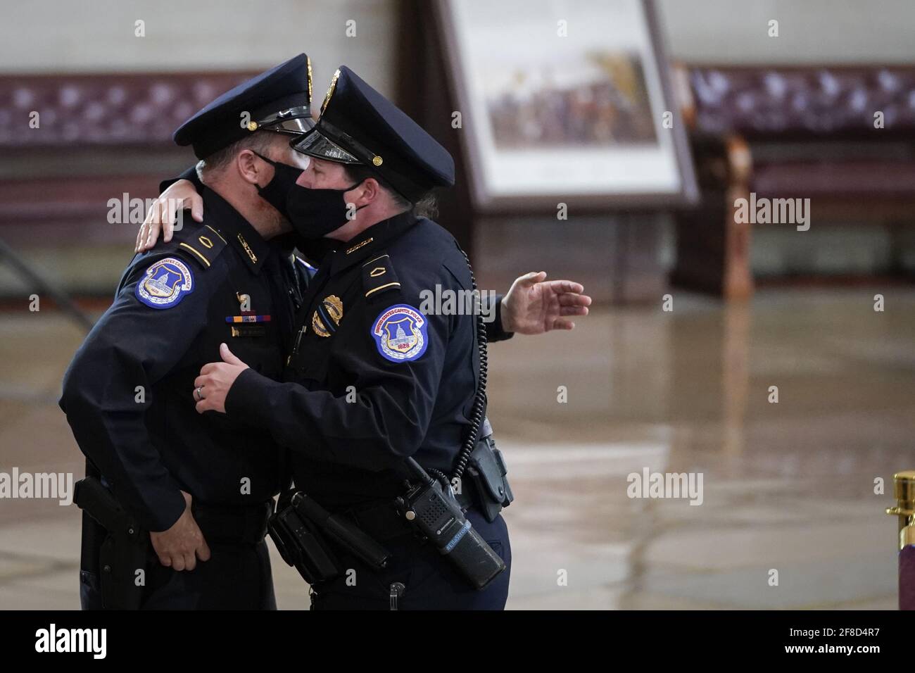 Capitol Police officers embrace after paying their respects at the casket of the late U.S. Capitol Police officer William 'Billy' Evans during a memorial service as Evans lies in honor in the Rotunda at the U.S. Capitol in Washington DC, on Tuesday April 13, 2021. Evans was killed in the line of duty during the attack outside the U.S. Capitol on April 2. Pool photo by Drew Angerer/UPI Credit: UPI/Alamy Live News Stock Photo
