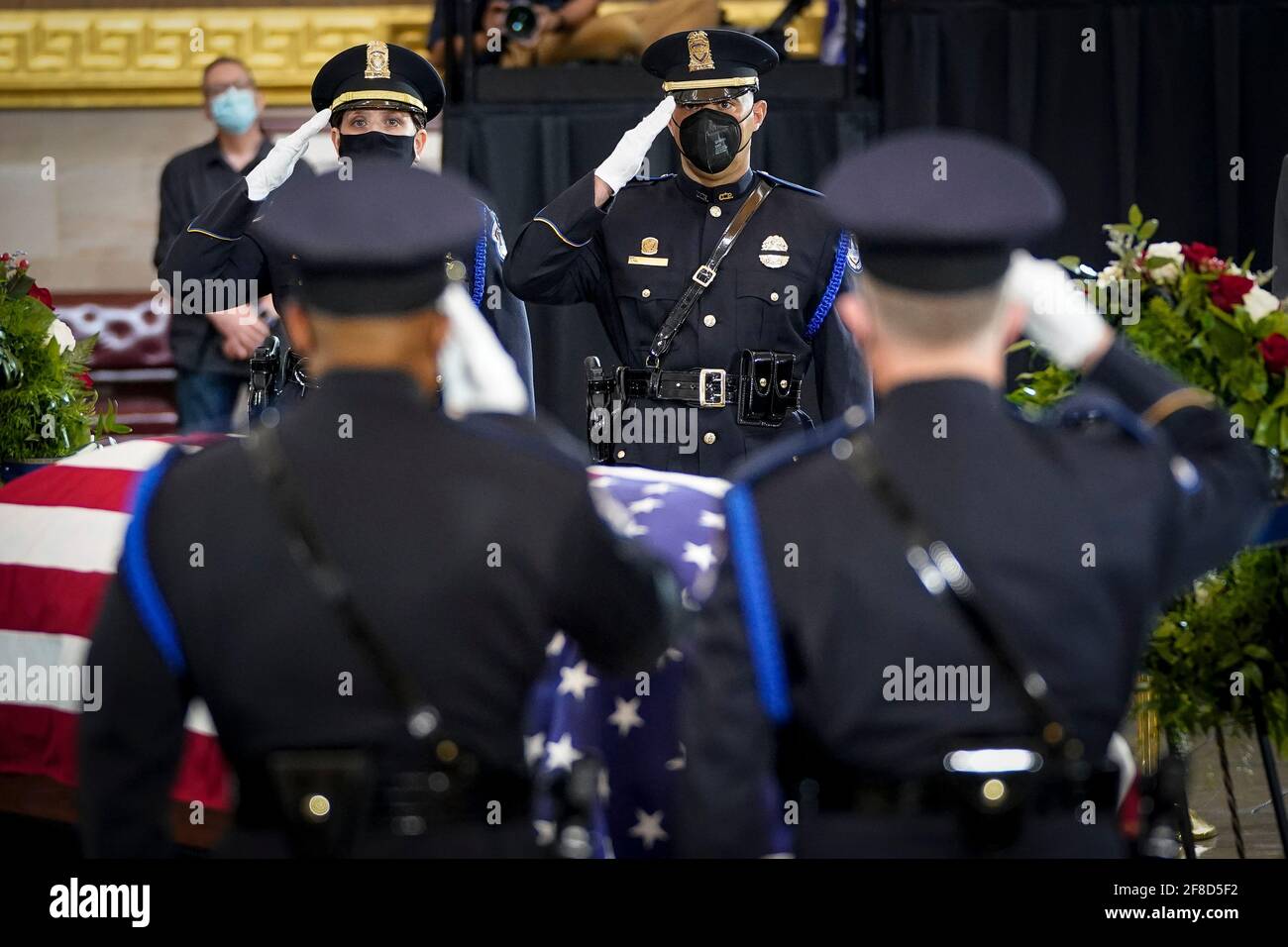 WASHINGTON, DC - APRIL 13: Members of a Capitol Police honor guard salute at the casket of the late U.S. Capitol Police officer William 'Billy' Evans during a memorial service as Evans lies in honor in the Rotunda at the U.S. Capitol on April 13, 2021 in Washington, DC. Officer Evans was killed in the line of duty during the attack outside the U.S. Capitol on April 2. He is the sixth Capitol Police officer to die in the line of duty in the nearly 200 years since the force was created. Credit: Drew Angerer/Pool via CNP | usage worldwide Stock Photo