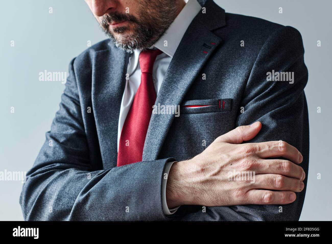 Arms gripping, restrained insecure businessman waiting for bad news, crossed arms posture body language, selective focus Stock Photo