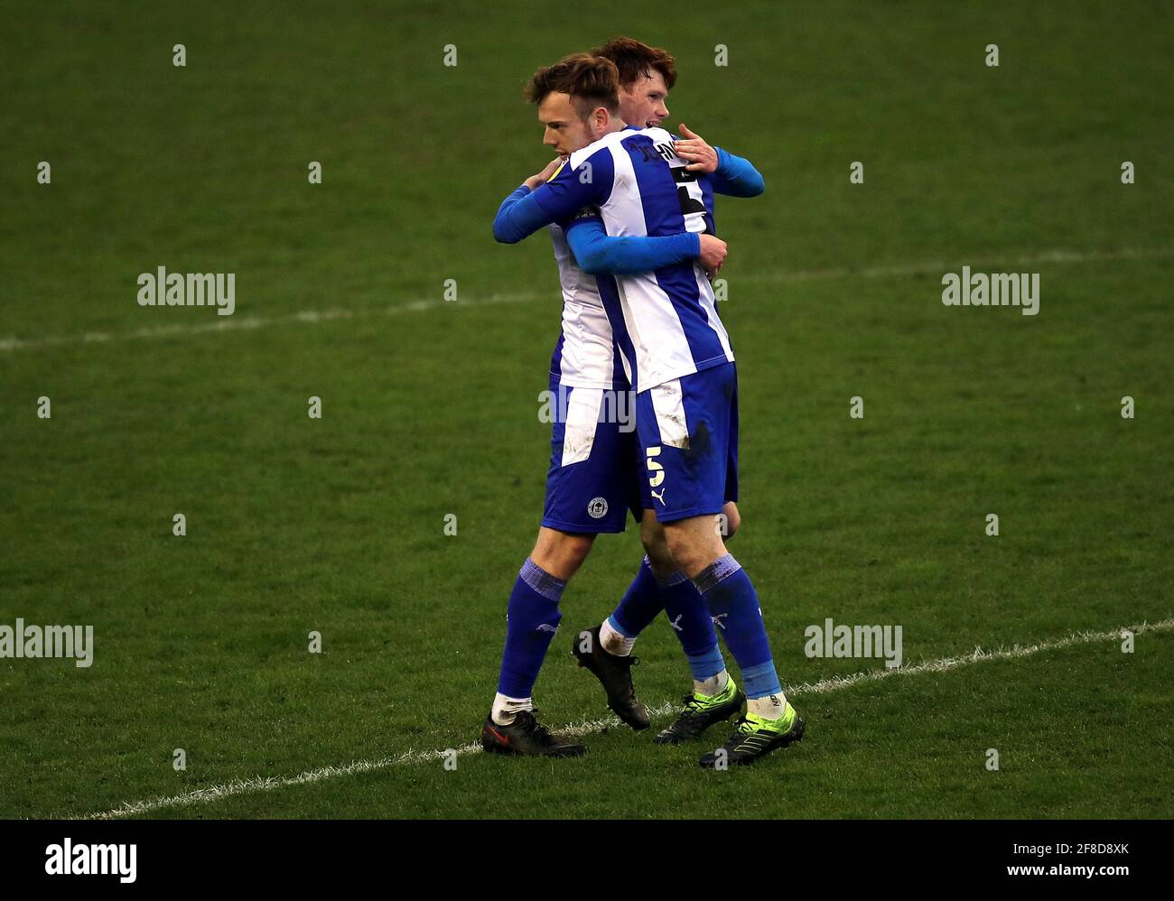 Wigan Athletic's Dan Gardner (left) and Luke Robinson celebrate after the final whistle during the Sky Bet League One match at the DW Stadium, Wigan. Picture date: Tuesday April 13, 2021. Stock Photo