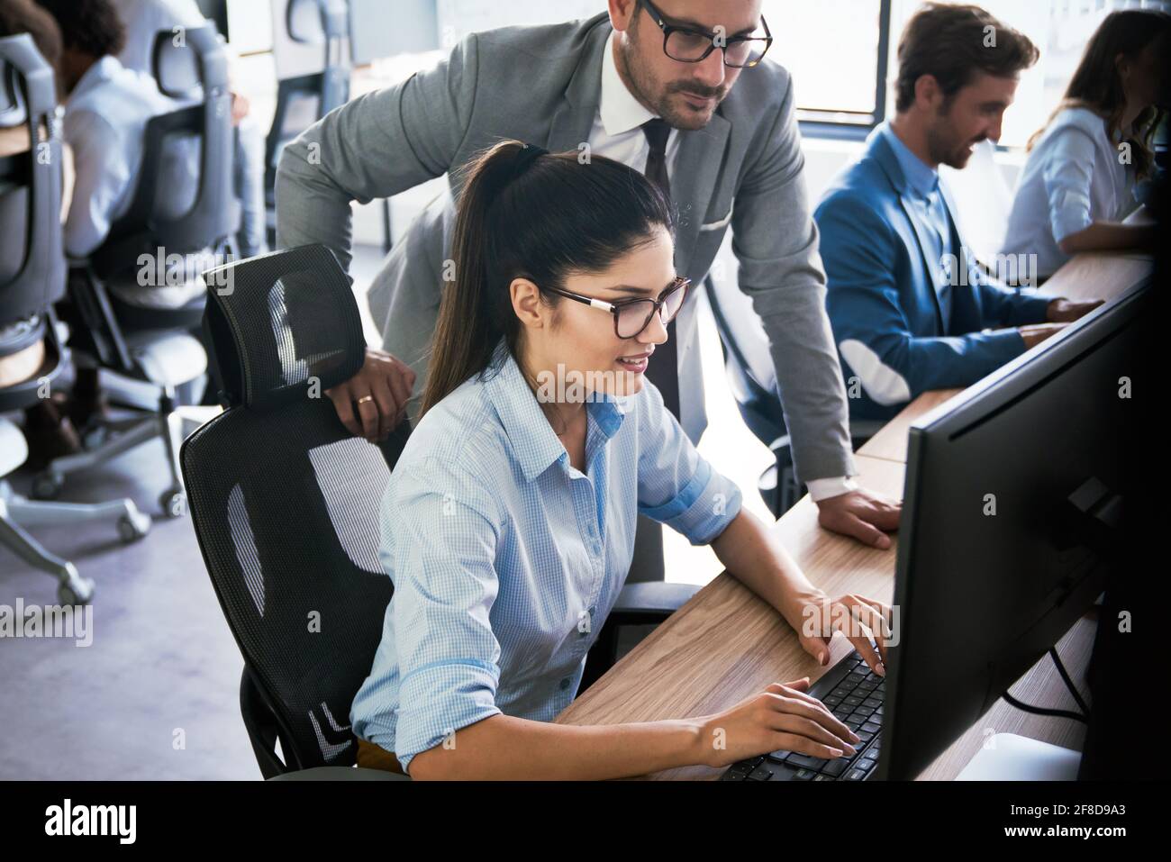 Programmers cooperating at IT company developing apps Stock Photo