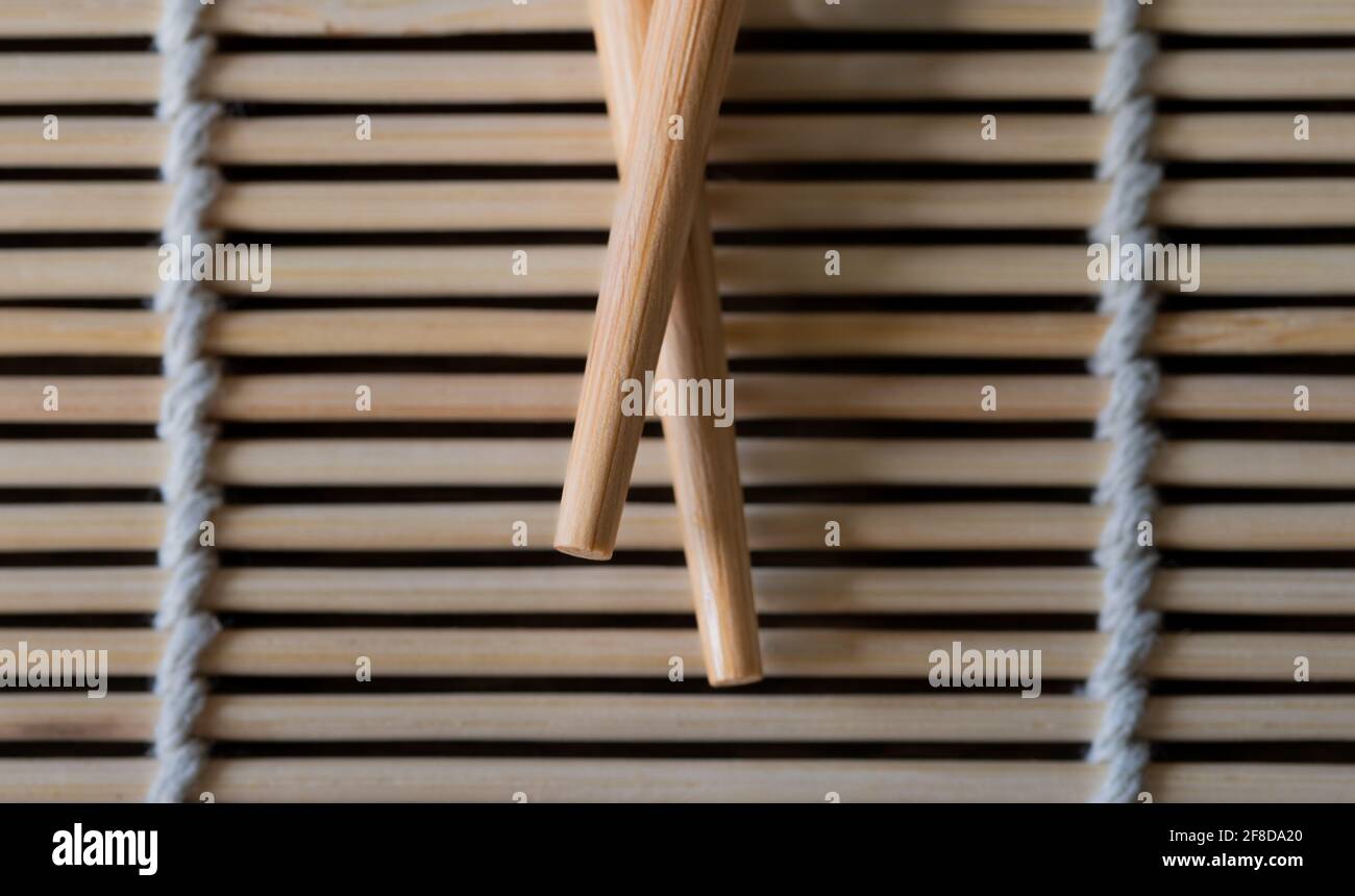 Close up of Chopsticks on a Bamboo Mat Stock Photo