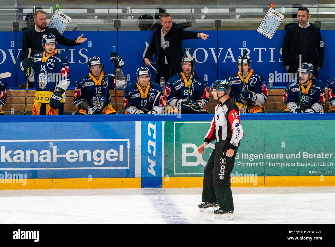 Bossard Arena, Zug, April 13th, 2021  Assistant Coach Klas Oestman (EV Zug) and Head Coach Dan Tangnes (EV Zug) complain to referee Nicolas Fluri (19) during the National League Playoff quarter-final ice hockey game 1 between EV Zug and SC Bern on April 13, 2021 in the Bossard Arena in train. (Switzerland/Croatia OUT) Credit: SPP Sport Press Photo. /Alamy Live News Stock Photo