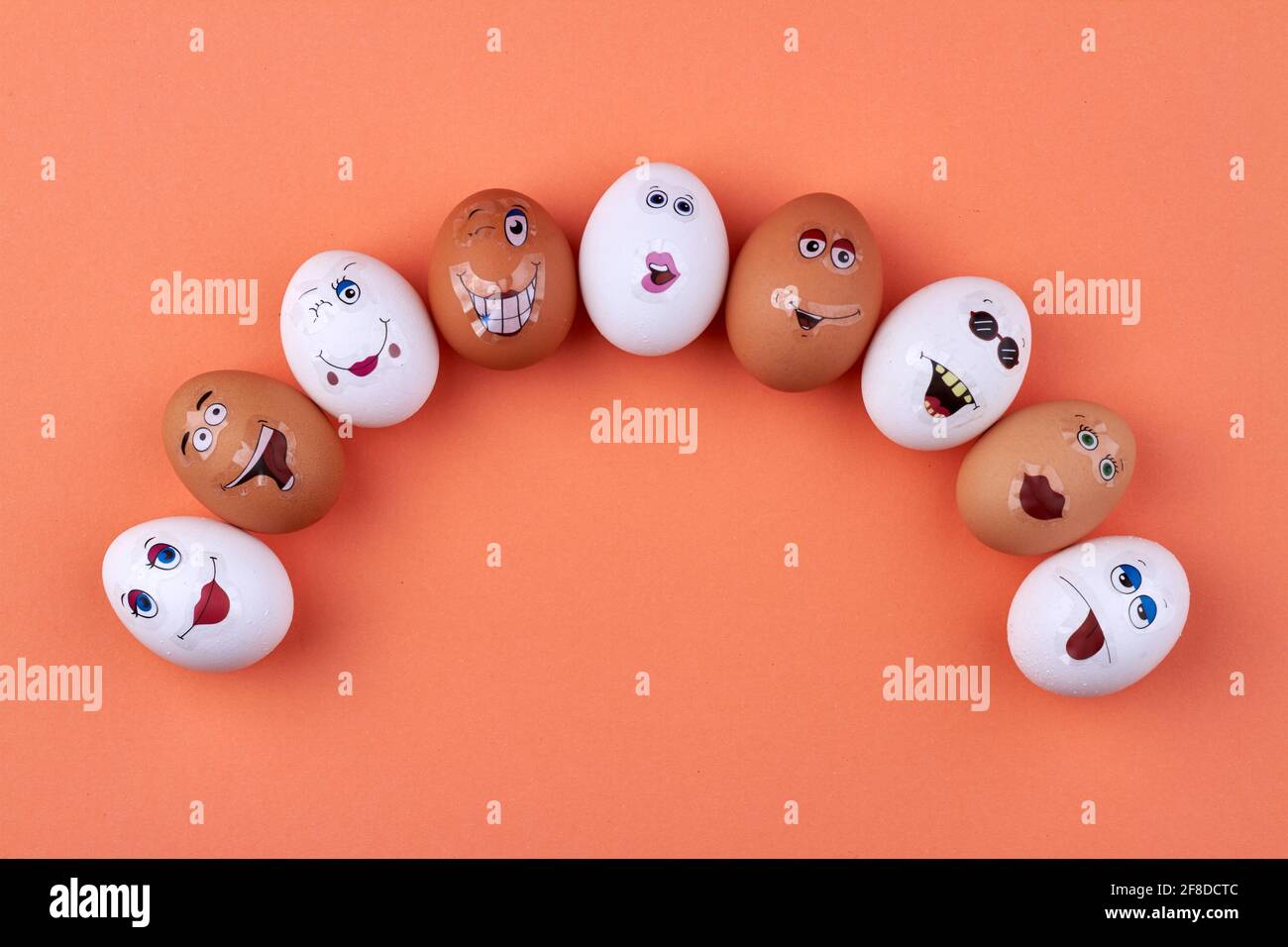 Group of white and brown eggs with smiley faces. Stock Photo