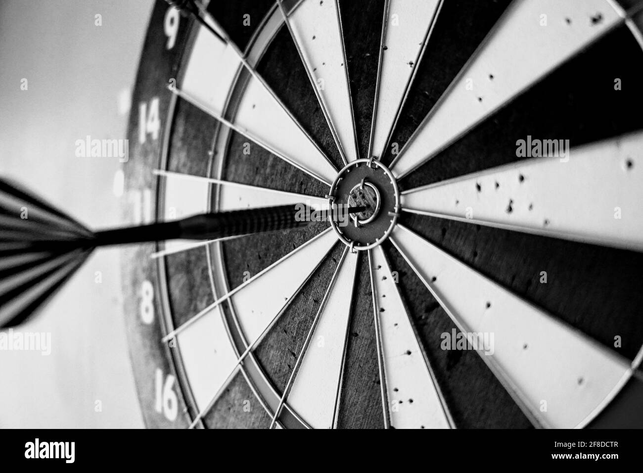 Grayscale shot of a dart hit the target Stock Photo