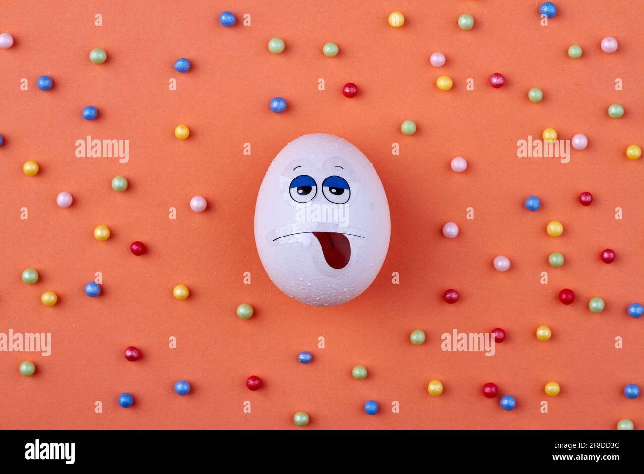 White egg with sad face. Stock Photo