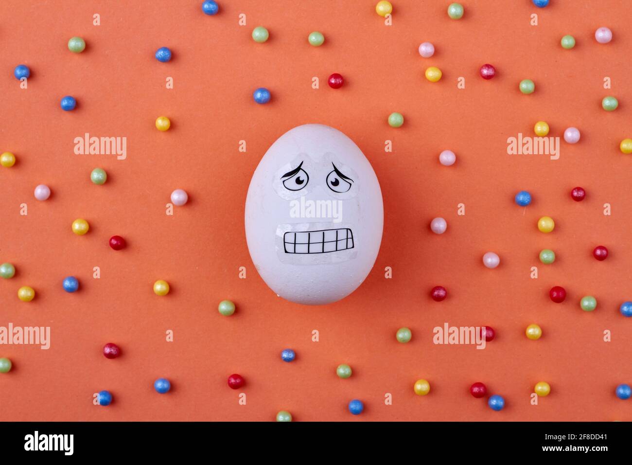 Chicken egg with scared facial expression. Stock Photo