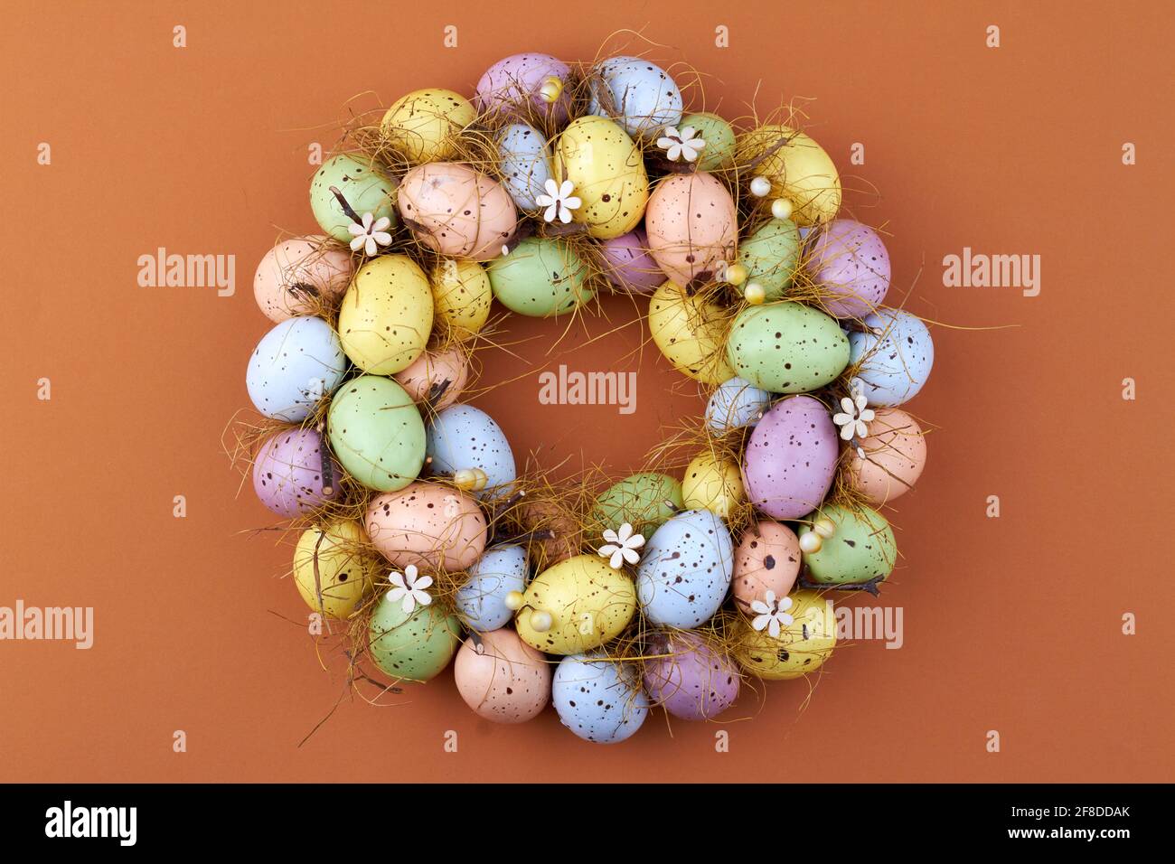 Motley easter eggs on brown background. Stock Photo