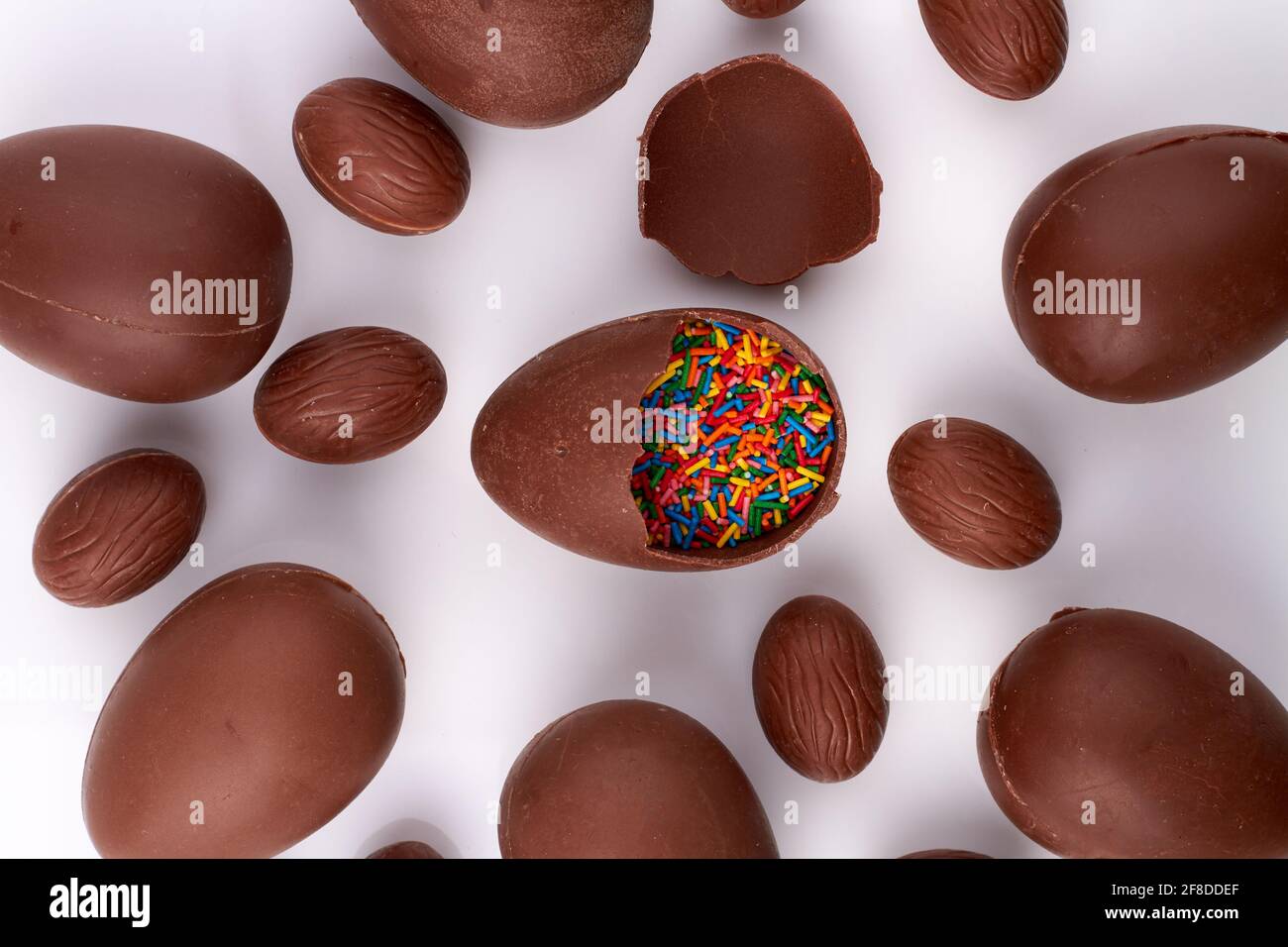 Chocolate easter egg filled with sprinkles Stock Photo Alamy