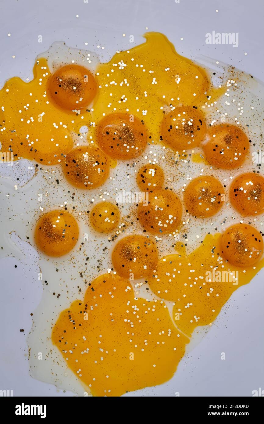 Yellow chicken egg yolks on white Stock Photo Alamy