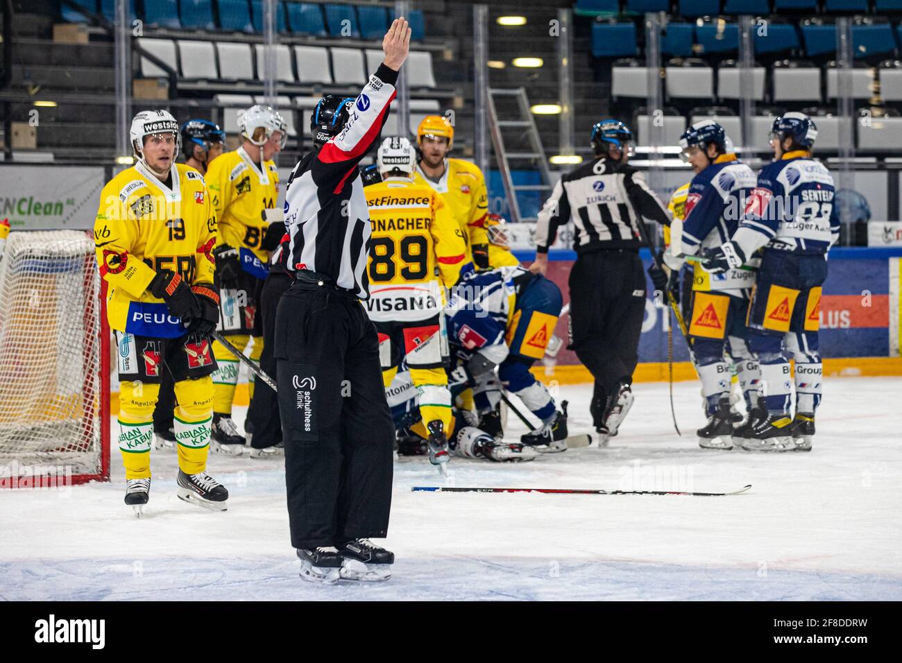 Bossard Arena, Zug, April 13th, 2021  A lot of work for the referee quartet around referee Nicolas Fluri (19) and referee Daniel Piechaczek (24) during the National League Playoff quarter-final ice hockey game 1 between EV Zug and SC Bern on April 13, 2021 in the Bossard Arena in Zug. (Switzerland/Croatia OUT) Credit: SPP Sport Press Photo. /Alamy Live News Stock Photo