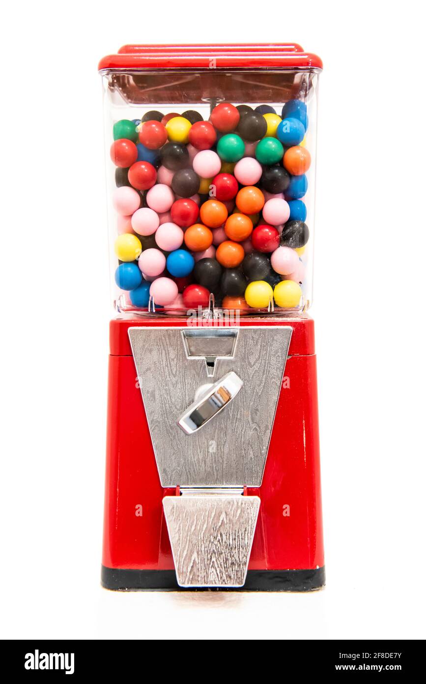 Traditional coin-operated gumball machine filled with multi coloured balls of chewing gum gobstoppers jawbreakers Stock Photo