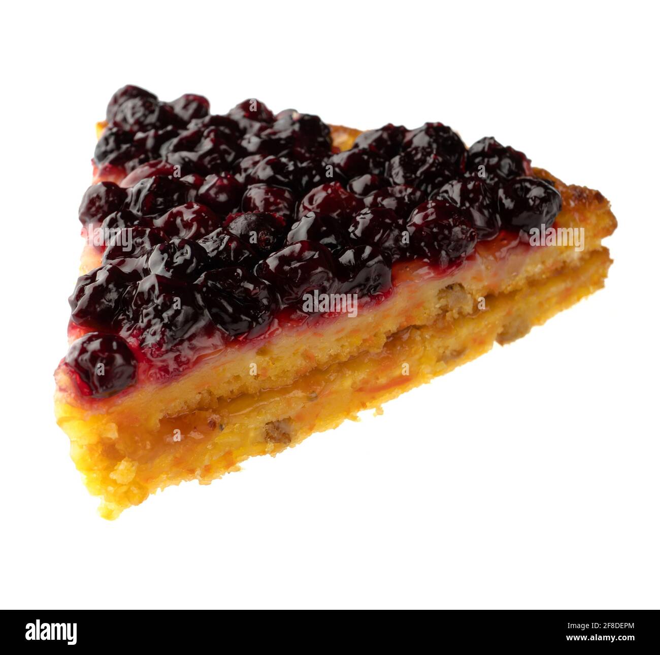 Sliced piece of carrot pie, sprinkled with currant berries on top, on white background Stock Photo