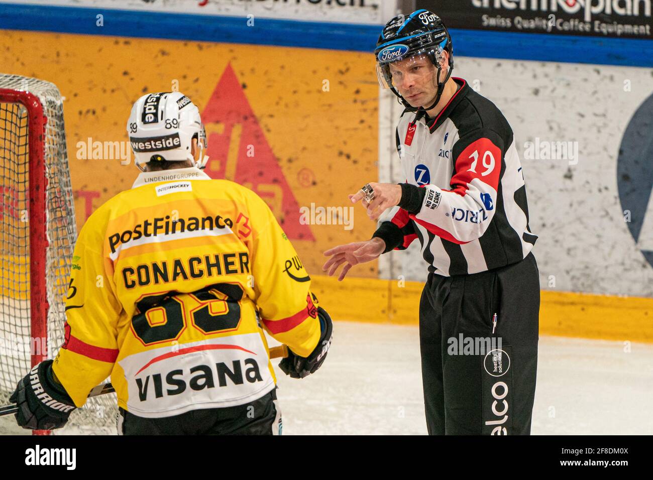 Bossard Arena, Zug, April 13th, 2021  Referee Nicolas Fluri (19) rightly points # 89 Cory Conacher (Bern) during the National League Playoff quarter final ice hockey game 1 between EV Zug and SC Bern on April 13th, 2021 in the Bossard Arena in Zug. (Switzerland/Croatia OUT) Credit: SPP Sport Press Photo. /Alamy Live News Stock Photo
