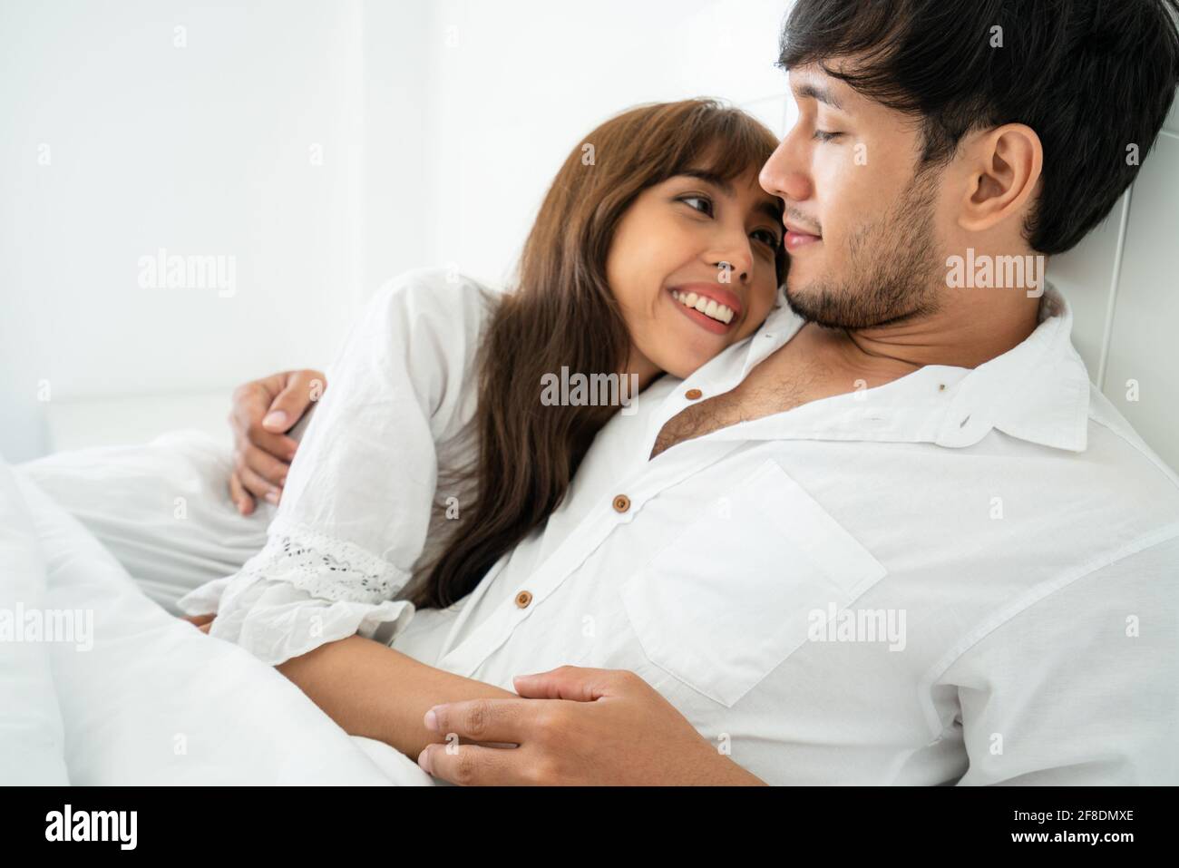 Happy young couple relaxing at home in the morning. Stock Photo