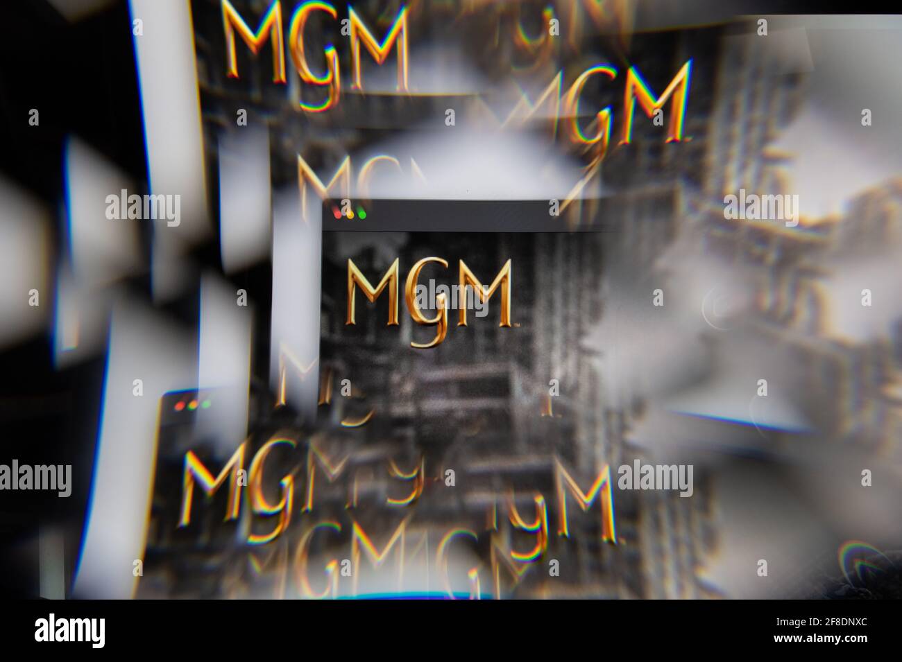 Milan, Italy - APRIL 10, 2021: MGM logo on laptop screen seen through an optical prism. Illustrative editorial image from MGM website. Stock Photo