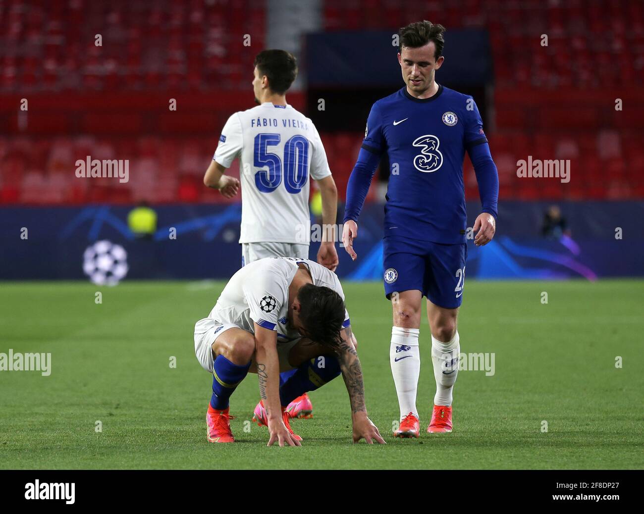 FC Porto's Mateus Uribe (left) appears dejected as Chelsea's Ben Chilwell looks on after the final whistle during the UEFA Champions League match at the Ramon Sanchez-Pizjuan Stadium, Seville. Picture date: Tuesday April 13, 2021. See PA story SOCCER Chelsea. Photo credit should read: Isabel Infantes/PA Wire. RESTRICTIONS: Editorial use only, no commercial use without prior consent from rights holder. Stock Photo