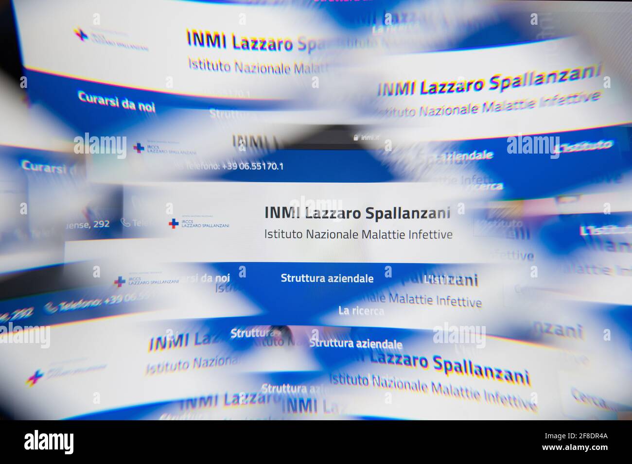 Milan, Italy - APRIL 10, 2021: ospedale spallanzani logo on laptop screen seen through an optical prism. Illustrative editorial image from ospedale sp Stock Photo