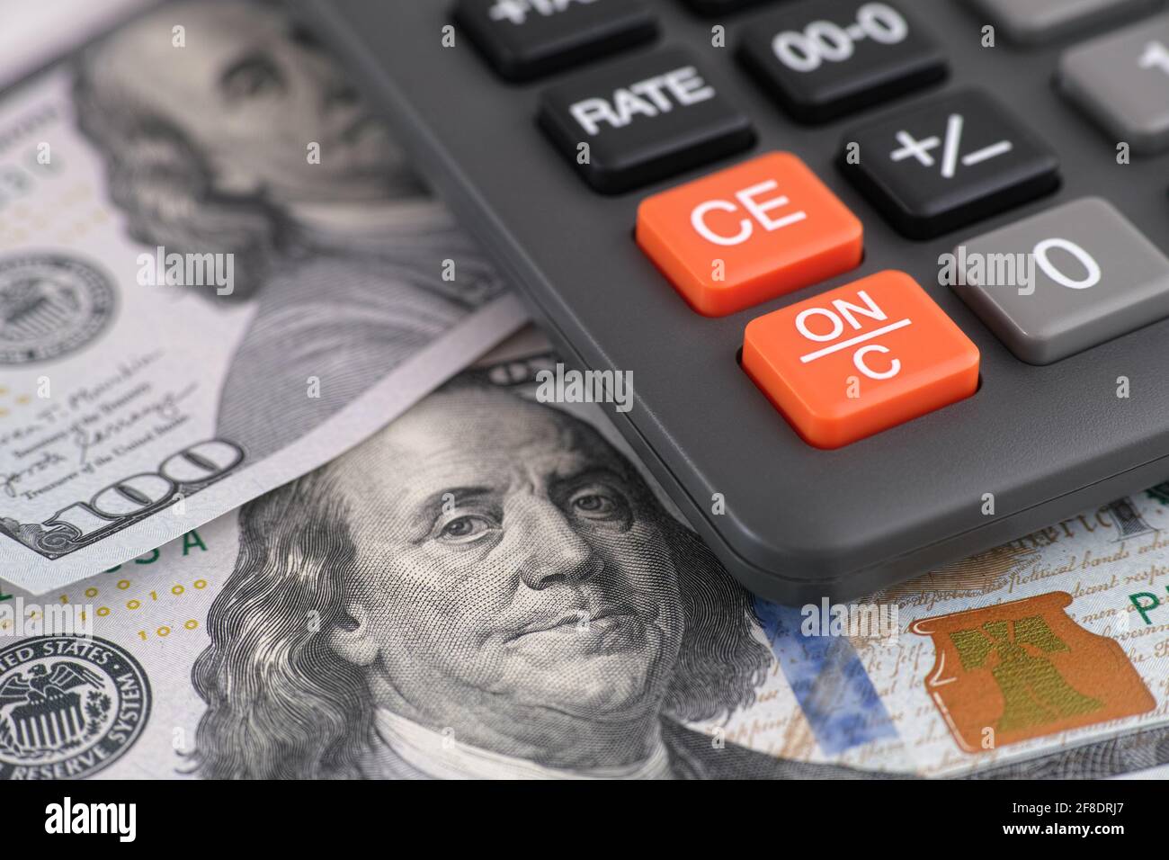 One hundred dollar bills and calculator. Close up. Stock Photo