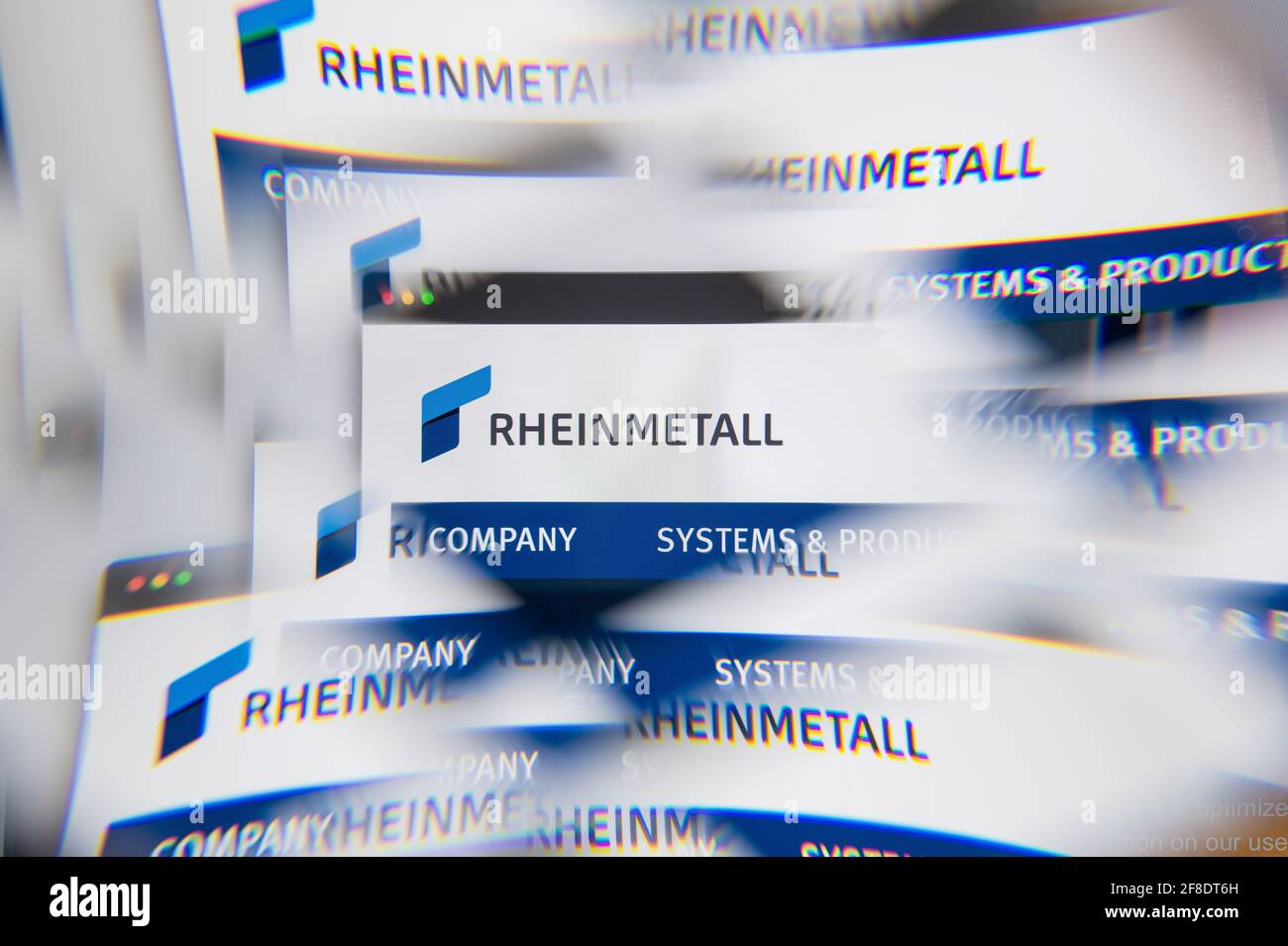 Milan, Italy - APRIL 10, 2021: Rheinmetall logo on laptop screen seen through an optical prism. Illustrative editorial image from Rheinmetall website. Stock Photo