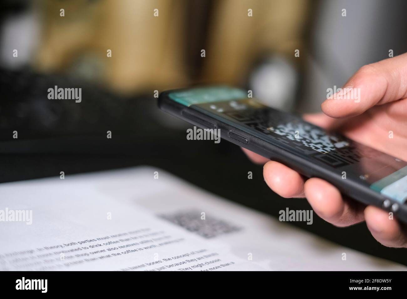 Man Scanning a QR code using a Smartphone.Contactless Payments technology Stock Photo