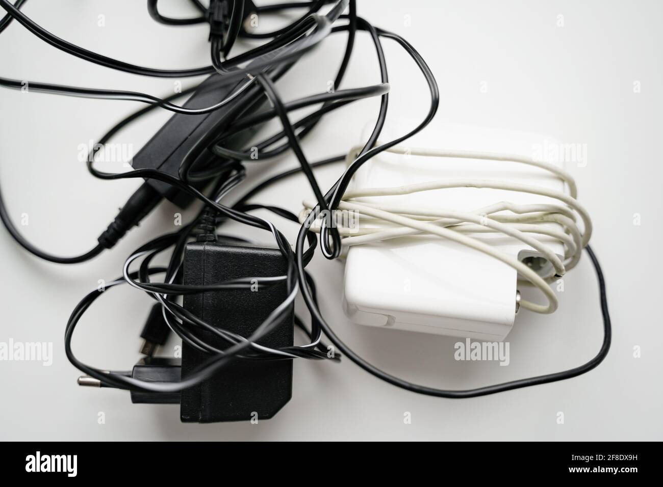 E waste, old cables and green plant. Gadget recycle of tech junk