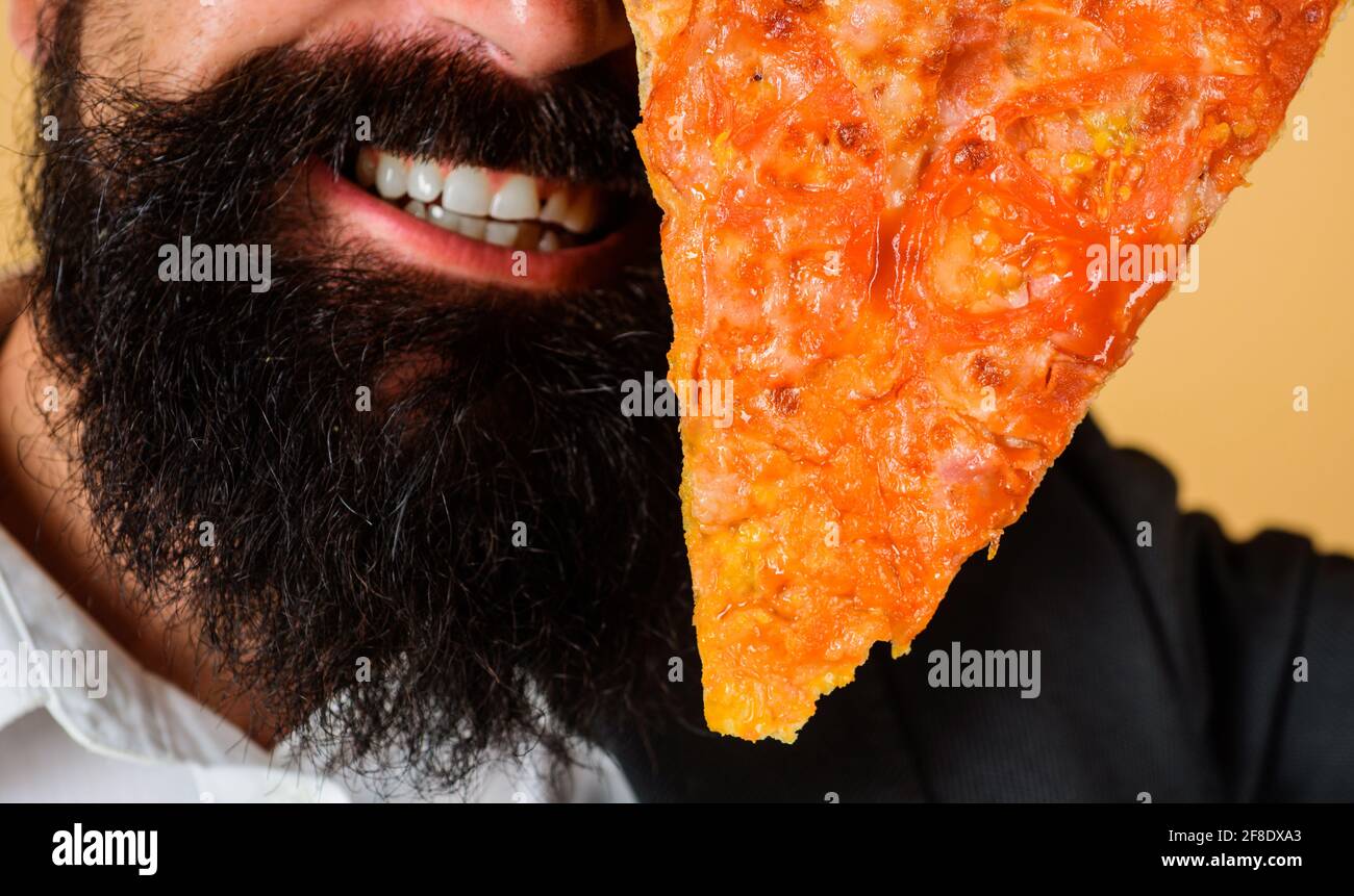 Pizzeria. Bearded man with slice of pizza. Italian cuisine. Delicious fast food. Stock Photo