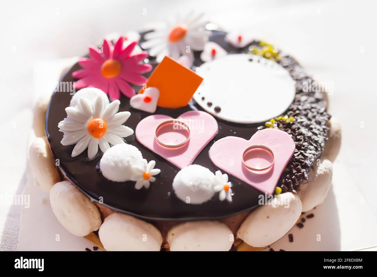 Engagement cake with a pair of gold rings decoration Stock Photo
