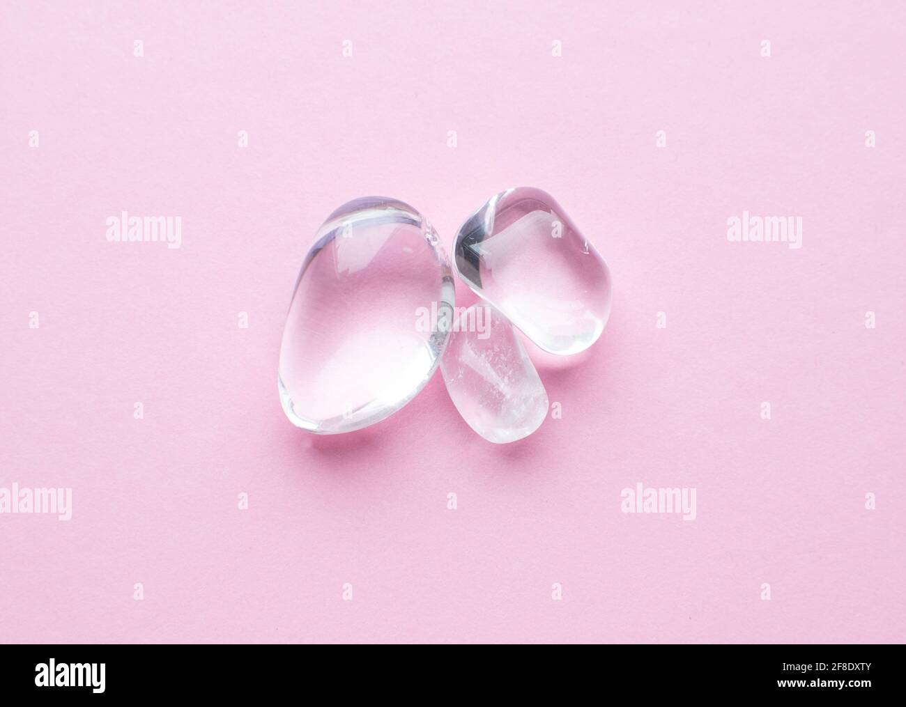 Beautiful round cut rhinestone stones on a pink background. Natural minerals for meditation. Stock Photo