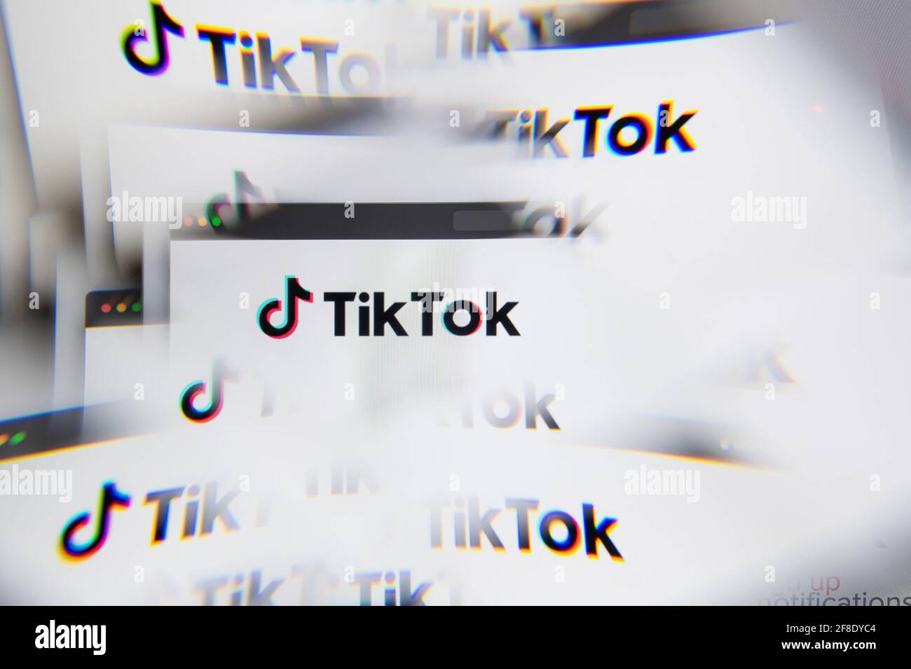 Milan, Italy - APRIL 10, 2021: TikTok logo on laptop screen seen through an optical prism. Illustrative editorial image from TikTok website. Stock Photo
