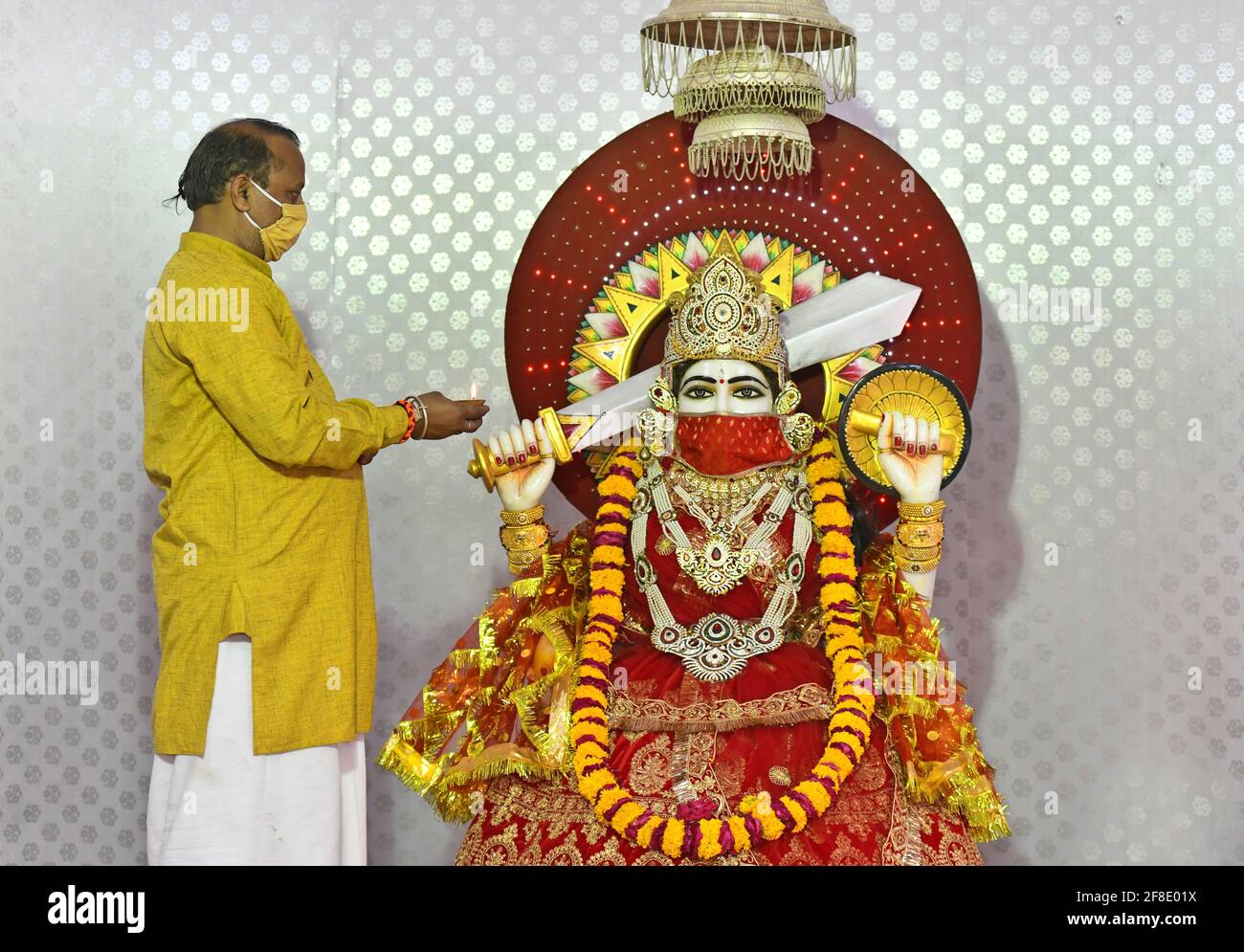 Beawar, India. 13th Apr, 2021. Hindu priest put protective face mask on the idol of Goddess Ashapura to create awareness about COVID-19 during Navratri festival celebrations amid the ongoing coronavirus pandemic. (Photo Beawar, India. 13th Apr, 2021. Hindu priest put protective face mask on the idol of Goddess Ashapura to create awareness about COVID-19 during Navratri festival celebrations amid the ongoing coronavirus pandemic. (Photo