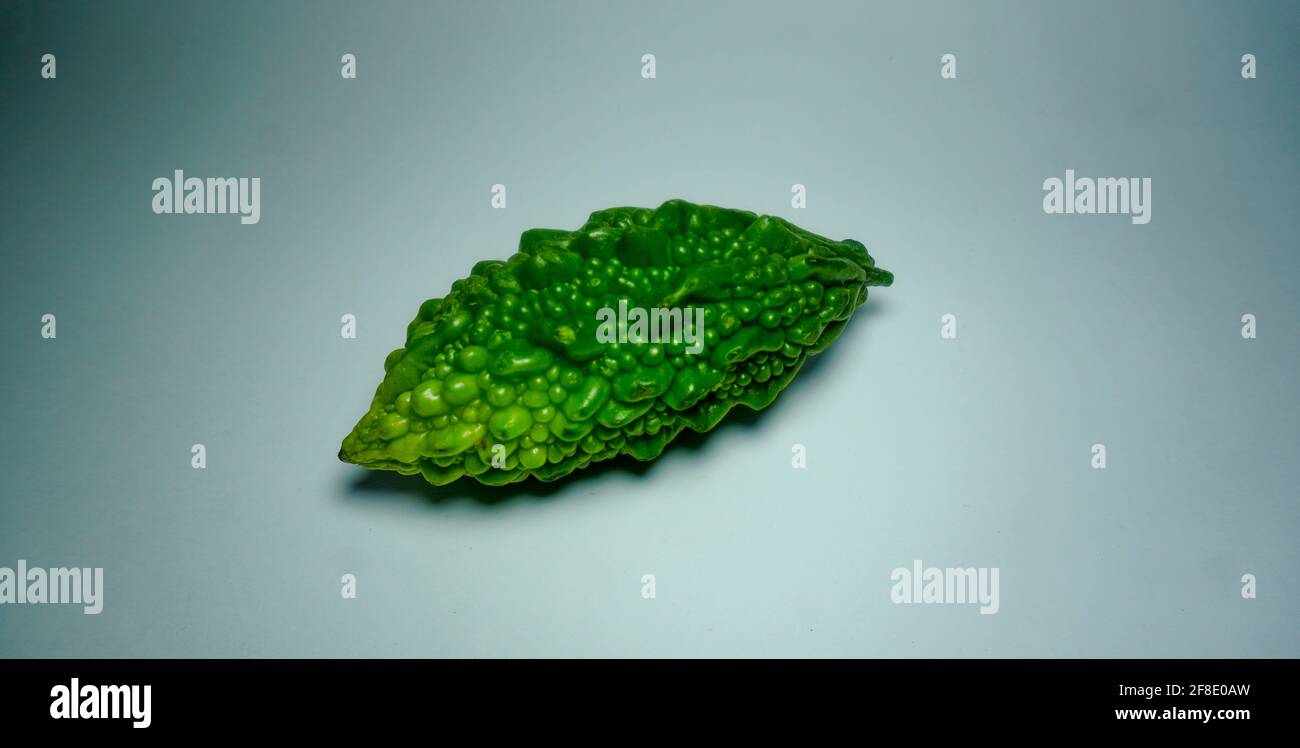 Fresh bitter melon on white. Healthy bitter melon for human body Stock