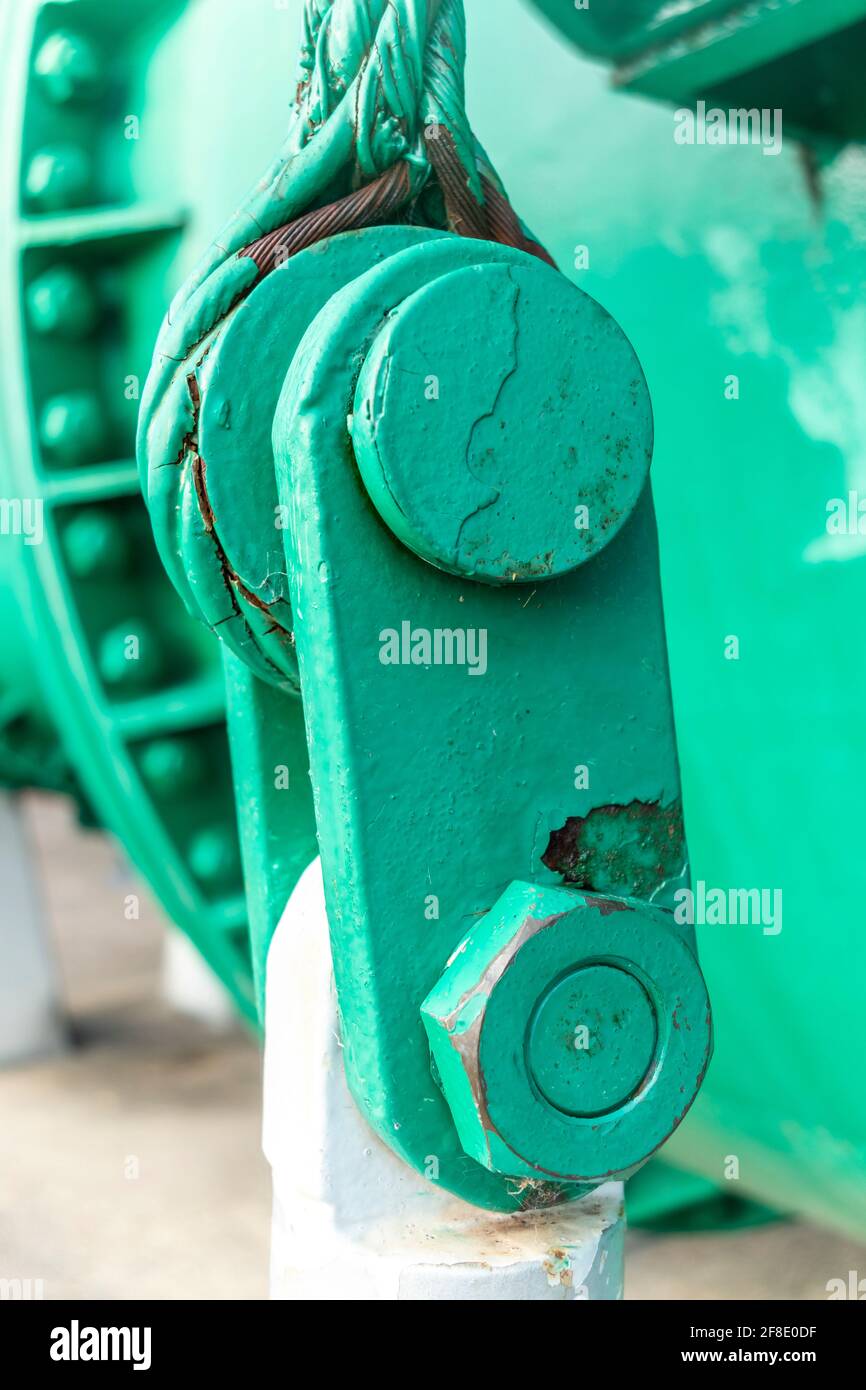 Close up view of of an old green steel shackle with a large nut and rusty steel cable Stock Photo