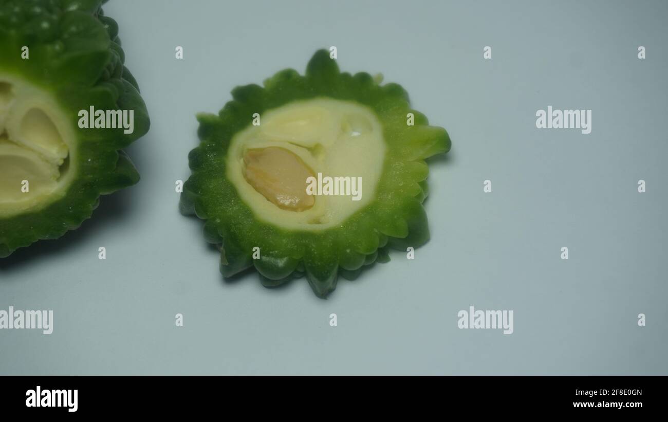 Fresh bitter melon on white. Healthy bitter melon for human body Stock