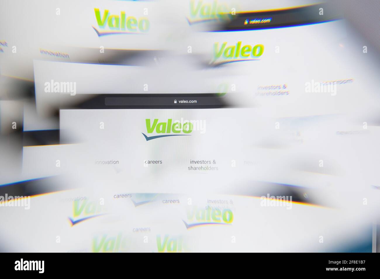 Milan, Italy - APRIL 10, 2021: Valeo logo on laptop screen seen through an optical prism. Illustrative editorial image from Valeo website. Stock Photo