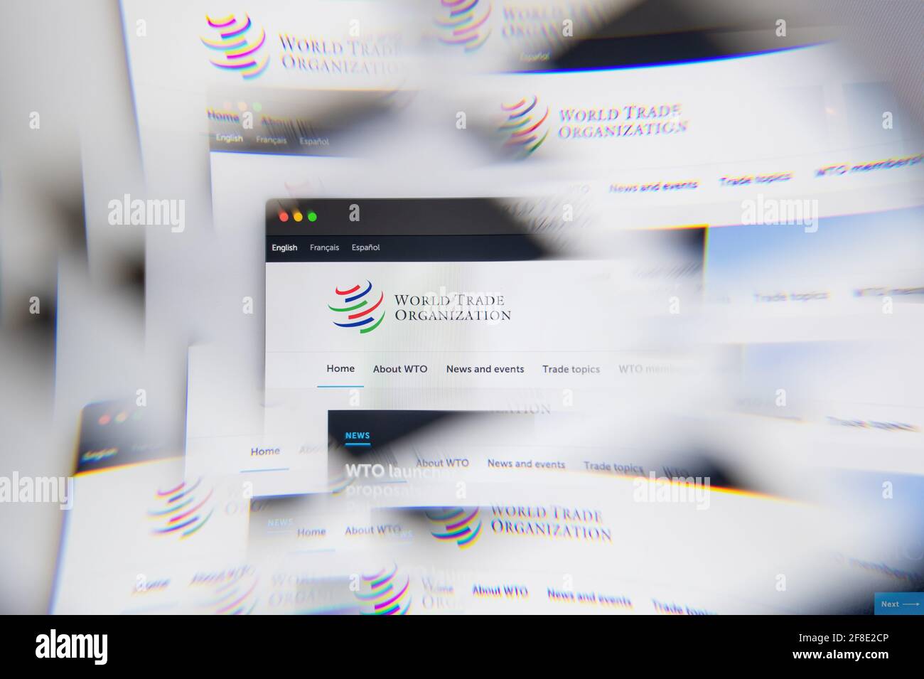 Milan, Italy - APRIL 10, 2021: World Trade Organization WTO logo on laptop screen seen through an optical prism. Illustrative editorial image from Wor Stock Photo