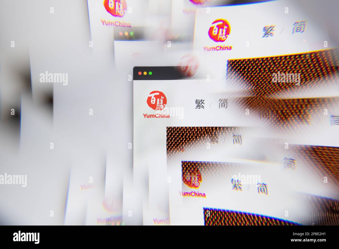 Milan, Italy - APRIL 10, 2021: Yum China logo on laptop screen seen through an optical prism. Illustrative editorial image from Yum China website. Stock Photo